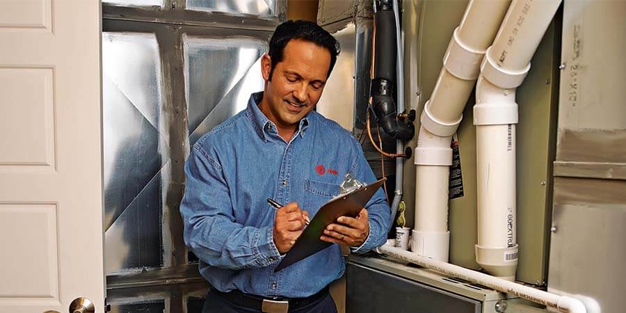 Service technician inspecting house